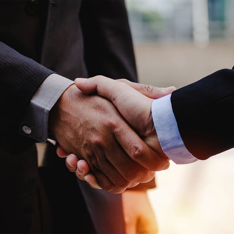 close up of business man in suit shaking hands after finishing u